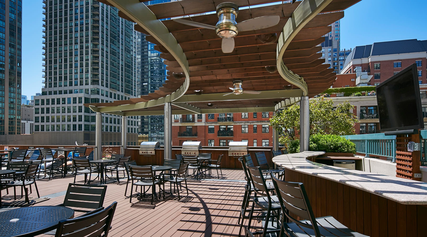 Access to Resident Only Features an outdoor grilling area with many seats and chairs