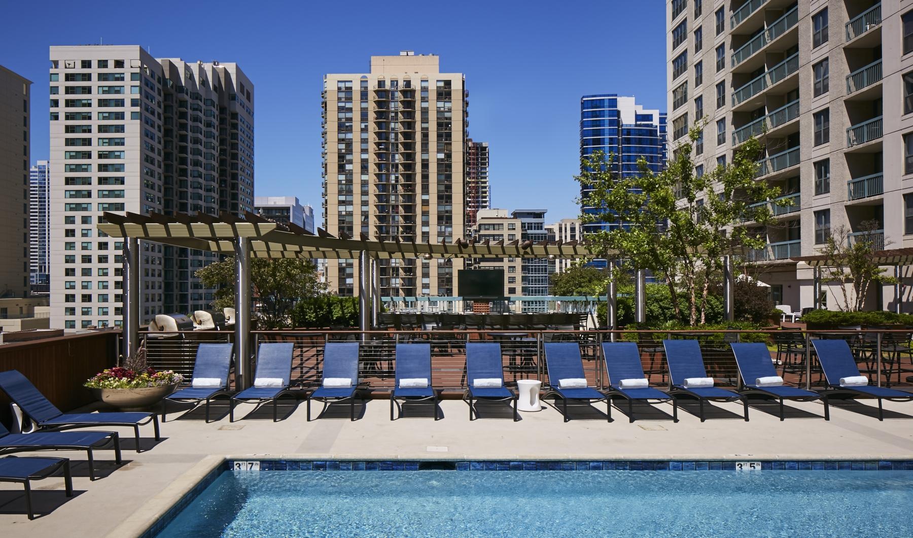 Resort-style swimming pool a pool with chairs around it
