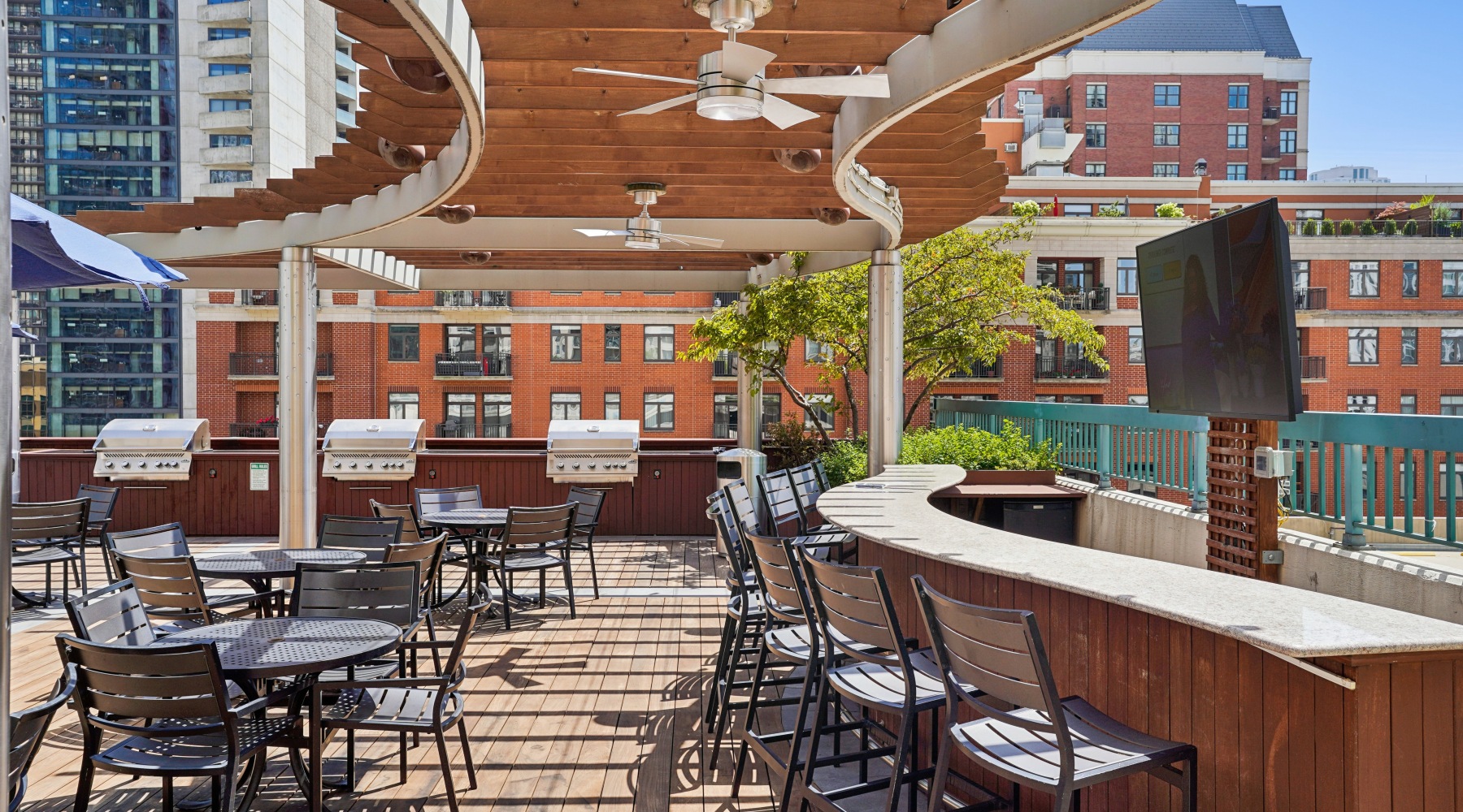 Rooftop lounge deck at One Superior Place with lots of seating and grill areas at our Chicago apartments.